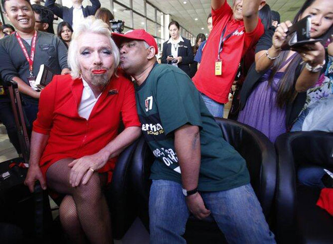 Richard Branson, de azafata, cumpliendo su apuesta con Tony Fernandes