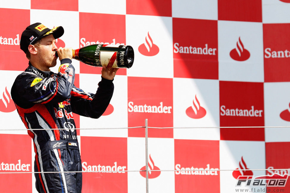 Vettel bebe de la botella de champán de segundo clasificado en Silverstone 2011