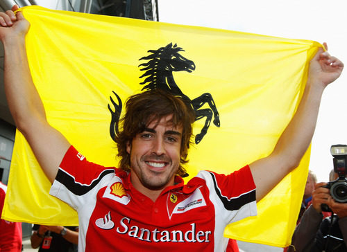 Fernando Alonso celebra su victoria con la bandera de Ferrari