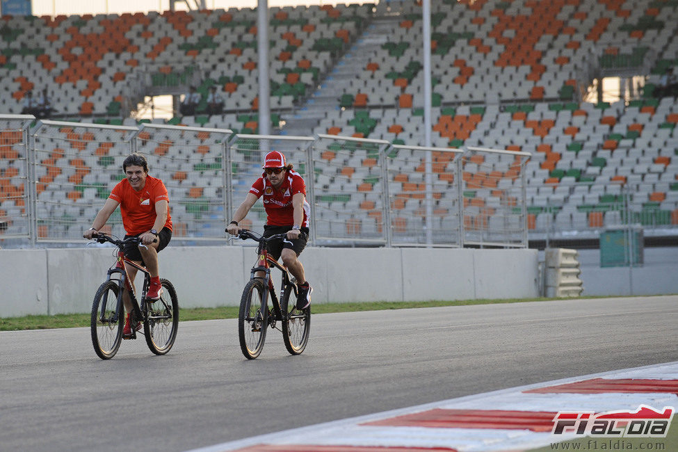 Fernando Alonso y su fisio recorren el circuito de India en bicicleta