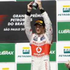 Jenson Button levanta su trofeo en el GP de Brasil 2011