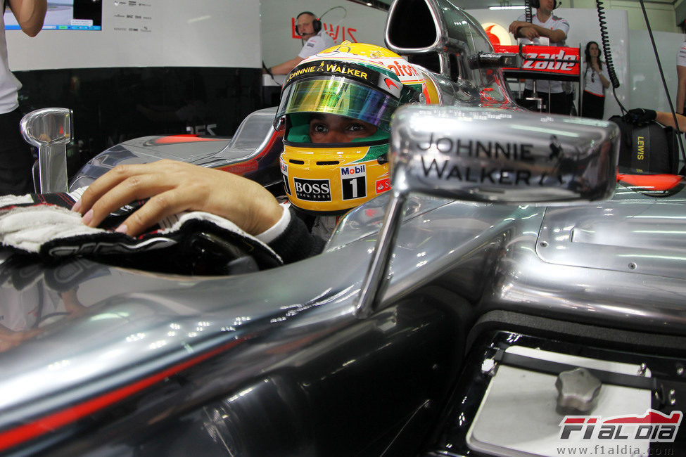 Lewis Hamilton sentado en su MP4-27
