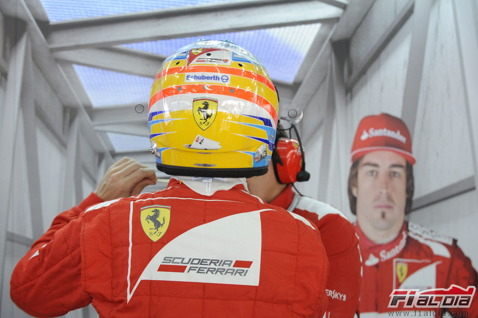Fernando Alonso se pone su casco en el box de Baréin