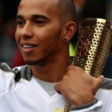 Lewis Hamilton abraza la antorcha olímpica de Londres