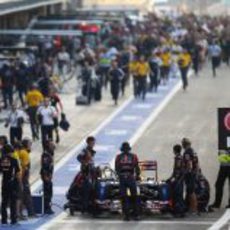 Los mecánicos de Red Bull preparan el coche de Vettel en el pit lane