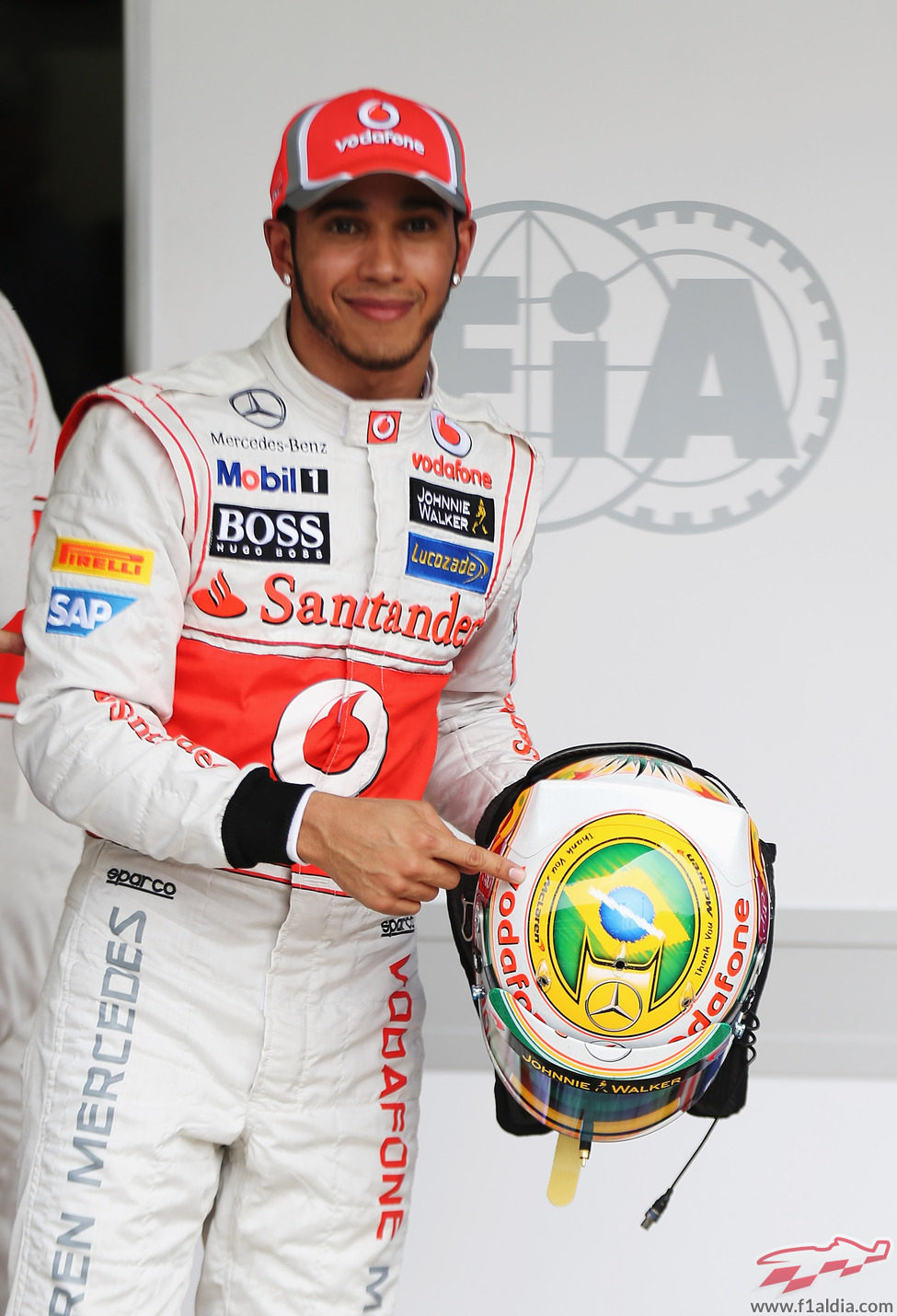 Lewis Hamilton señala su casco tras lograr la 'pole' en Brasil 2012