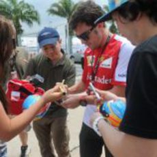 Fernando Alonso firma autógrafos en Sepang