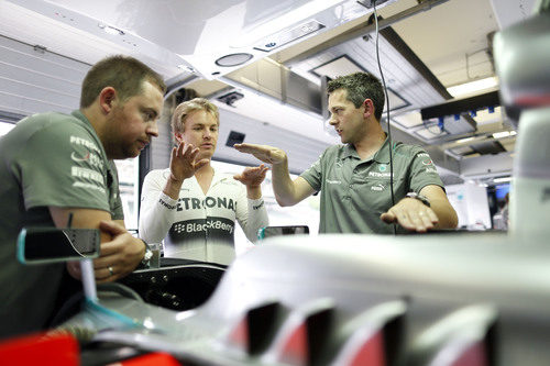 Nico Rosberg conversa con los mecánicos