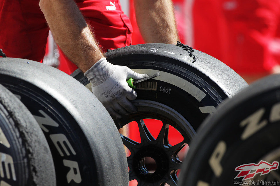 Un operario de Ferrari limpiando los neumáticos