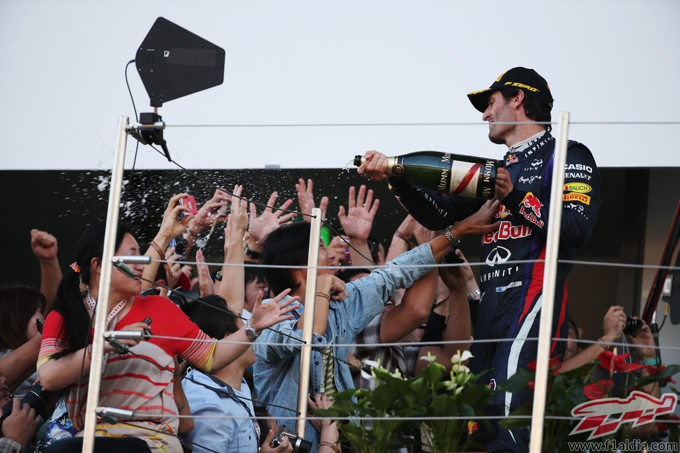 Mark Webber celebra el podio con los aficionados