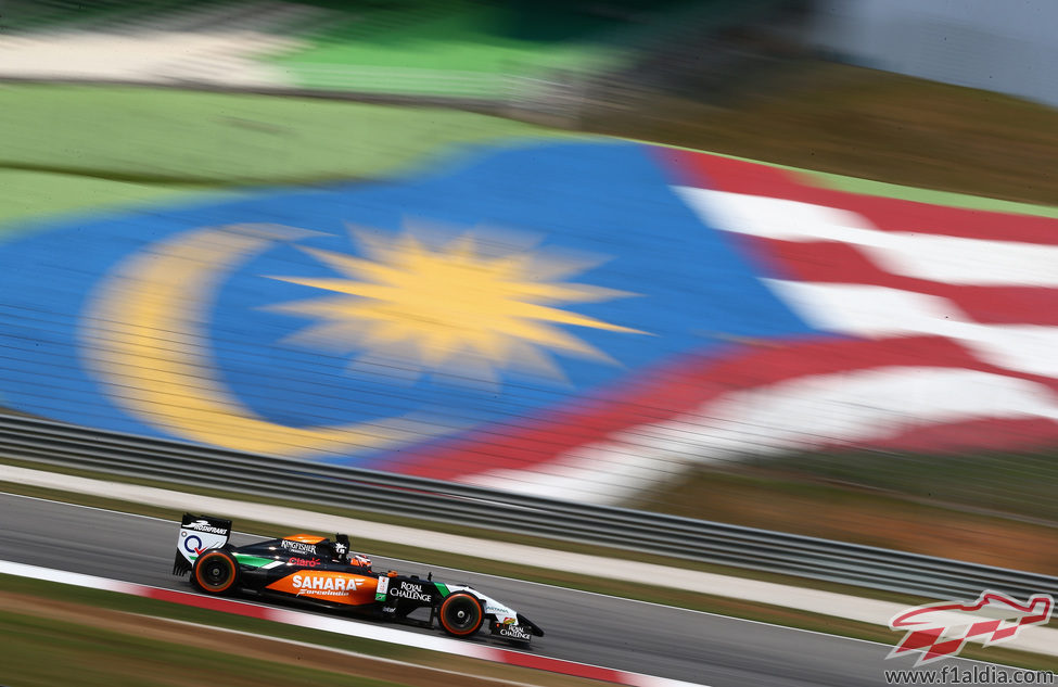 Nico Hülkenberg pasa por delante de una gran bandera de Malasia