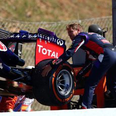 Sebastian Vettel ayuda a retirar el RB10 de la pista