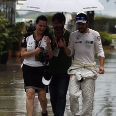 Fernando Alonso en el paddock bajo la lluvia