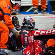 Los comisarios ayudan a salir del coche a Max Verstappen