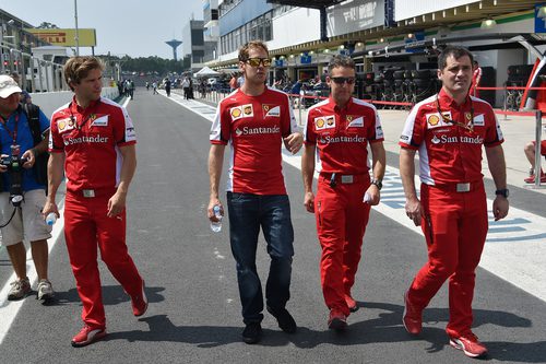 Sebastian Vettel comprobando la pista con sus ingenieros