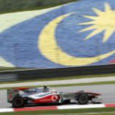 Hamilton ante la bandera de Malasia pintada en la pista