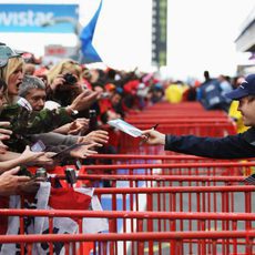 Sebastian Vettel firma autógrafos para los aficionados