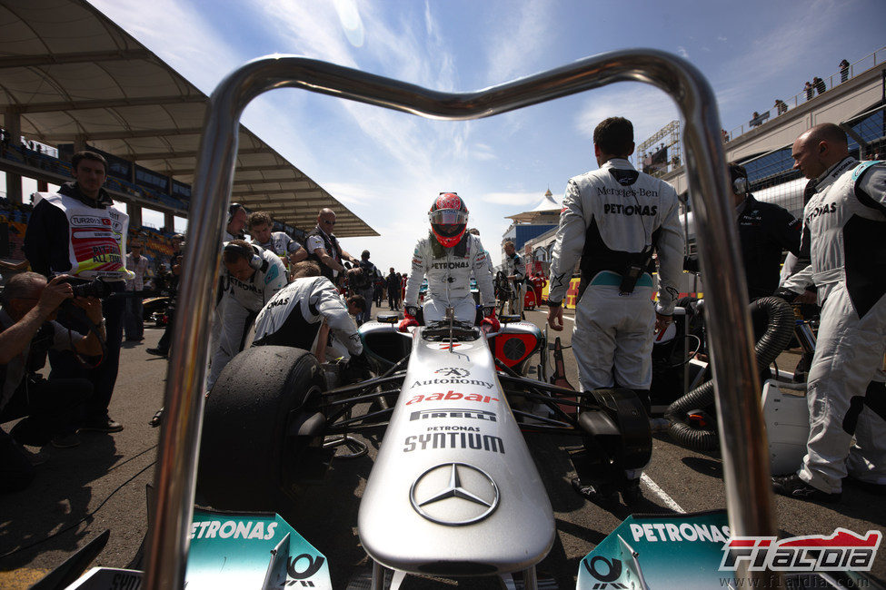 Michael Schumacher se sube a su W02 en la parrilla de Turquía 2011