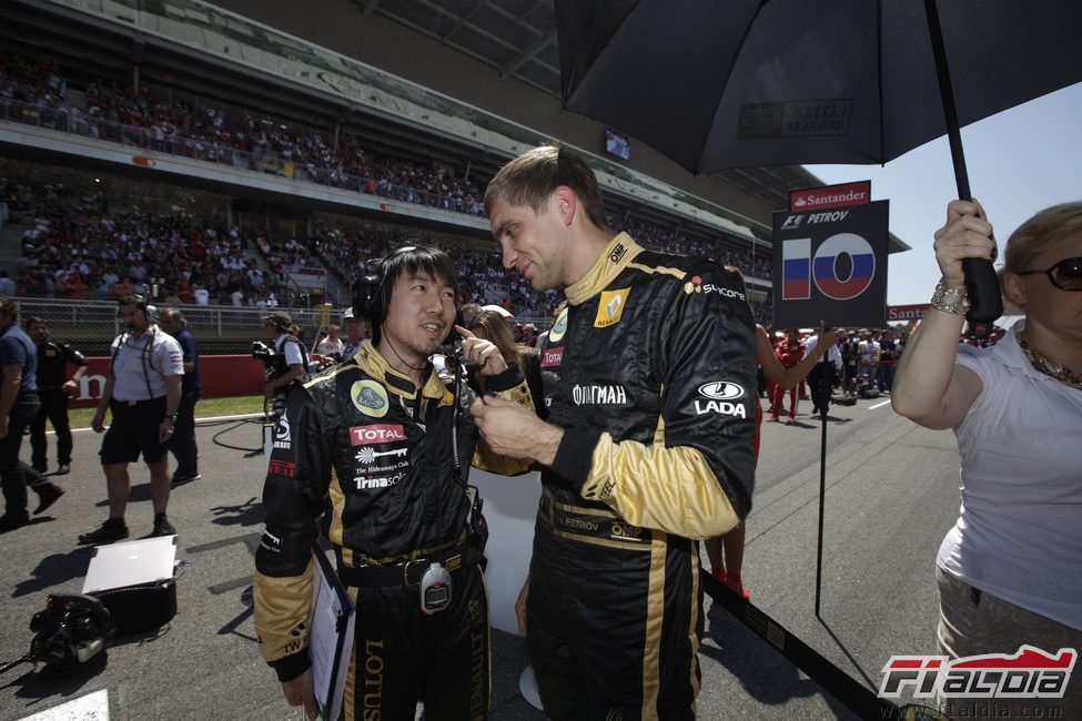 Petrov charla con su ingeniero en la parrilla del GP de España 2011