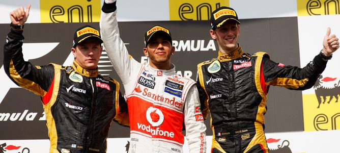 Lewis Hamilton acompañado en el podio por los dos pilotos de Lotus, Kimi Räikkönen y Romain Grosjean